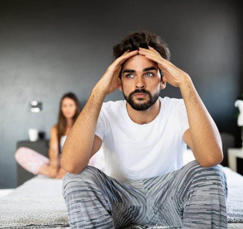 Unhappy couple having arguments and sexual problems in bed