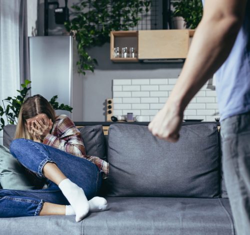 Family quarrel, couple man and woman, domestic violence, family crisis woman Family quarrel, couple man and woman, domestic violence, family crisis woman sitting on sofa and crying