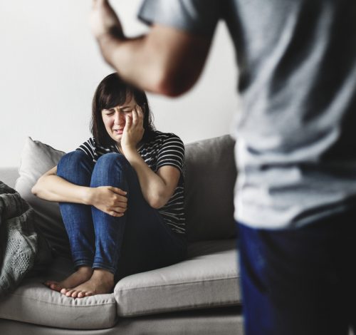 Unhappy couple arguing on the sofa